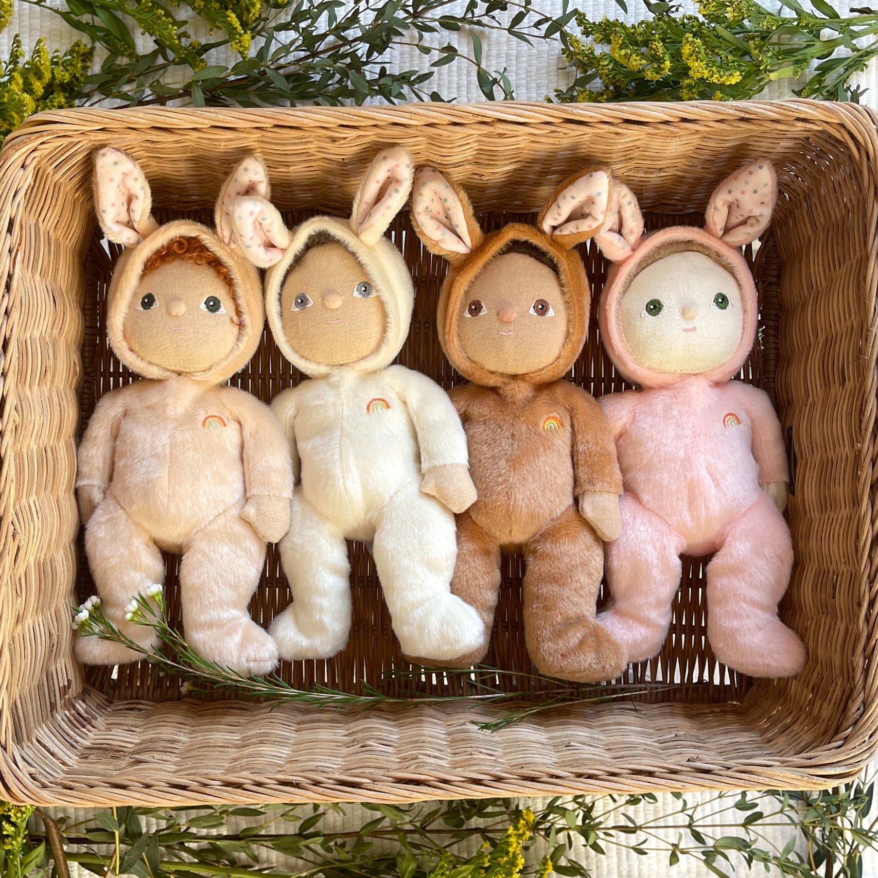 Four Olli Ella Bunny Dinky Dinkum Dolls laying in a basket. Bubba, Basil, Bucky and Babbit bunnies. 