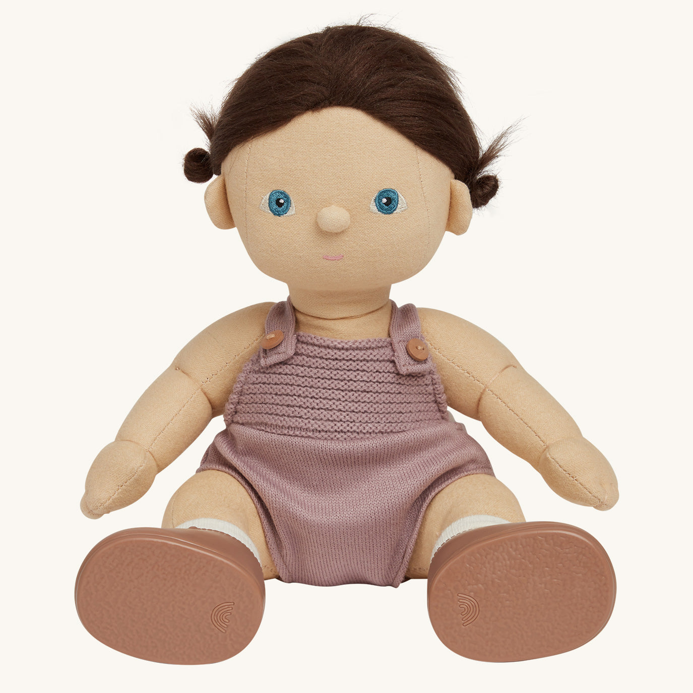 soft bodied Dinkum Doll sitting down pictured on a plain coloured background