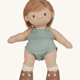 An Olli Ella Gigi Dinkum doll. The doll has blonde hair worn down and brown eyes. The doll is in a standing position and is wearing a mint green coloured knitted outfit and light brown coloured shoes. Shown on a plain background.  