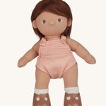 An Olli Ella Dottie Dinkum Doll on a plain background. The doll has brown hair and brown eyes. The hair is shown down. 