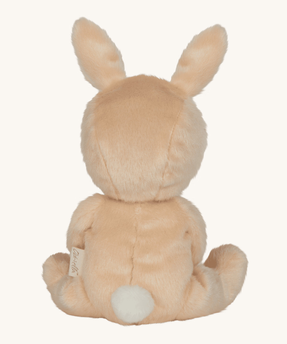 Olli Ella light sand coloured Bubba Bunny Dinky Dinkum Doll in a seated position facing away from the camera. The back of the dolly can be seen with a white fluffy tail on. 
