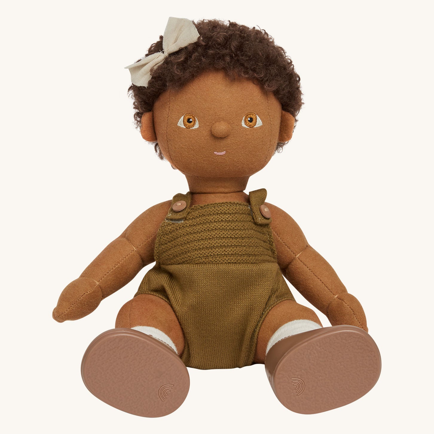 Dinkum Doll standing up pictured on a plain coloured background