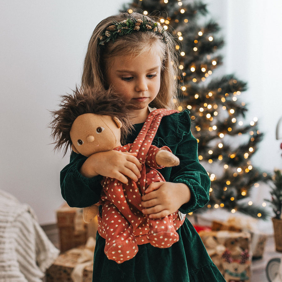 Olli Ella Doll Carrier in Sweetheart Red being worn by a child