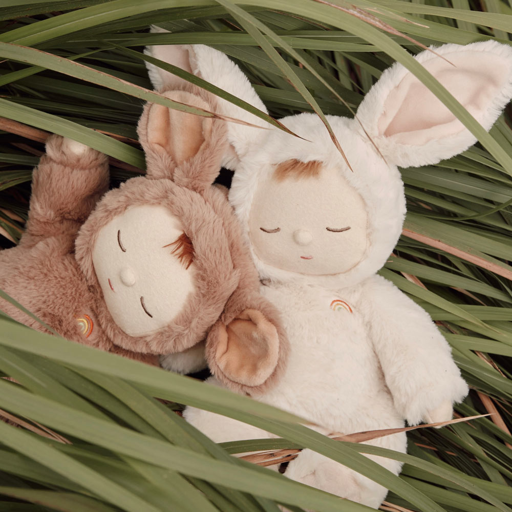 2 Olli Ella cozy dozy dinkum doll toys laying in some long green grass