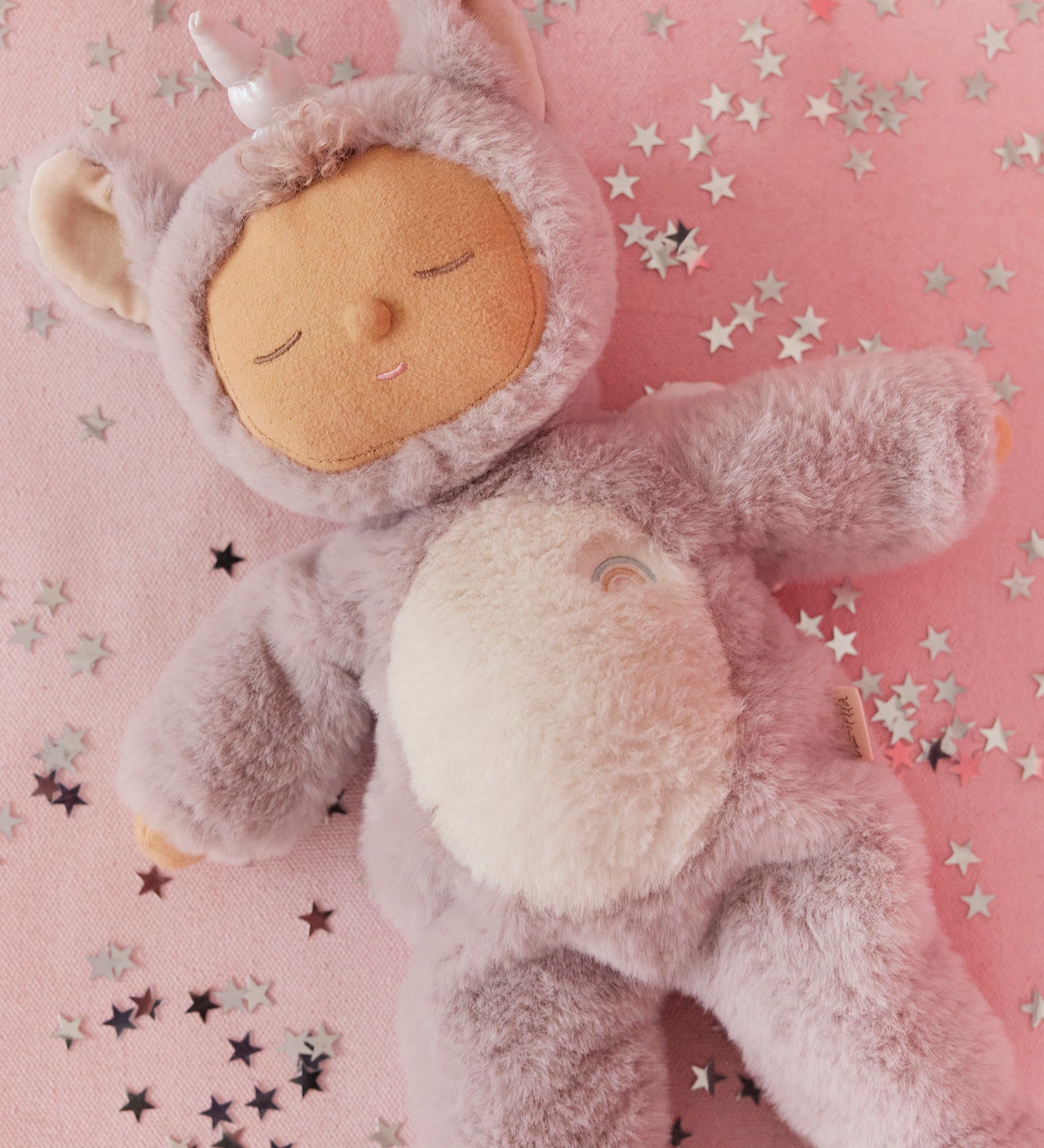 A lilac fluffy unicorn Olli Ella dozy dinkum doll lying down