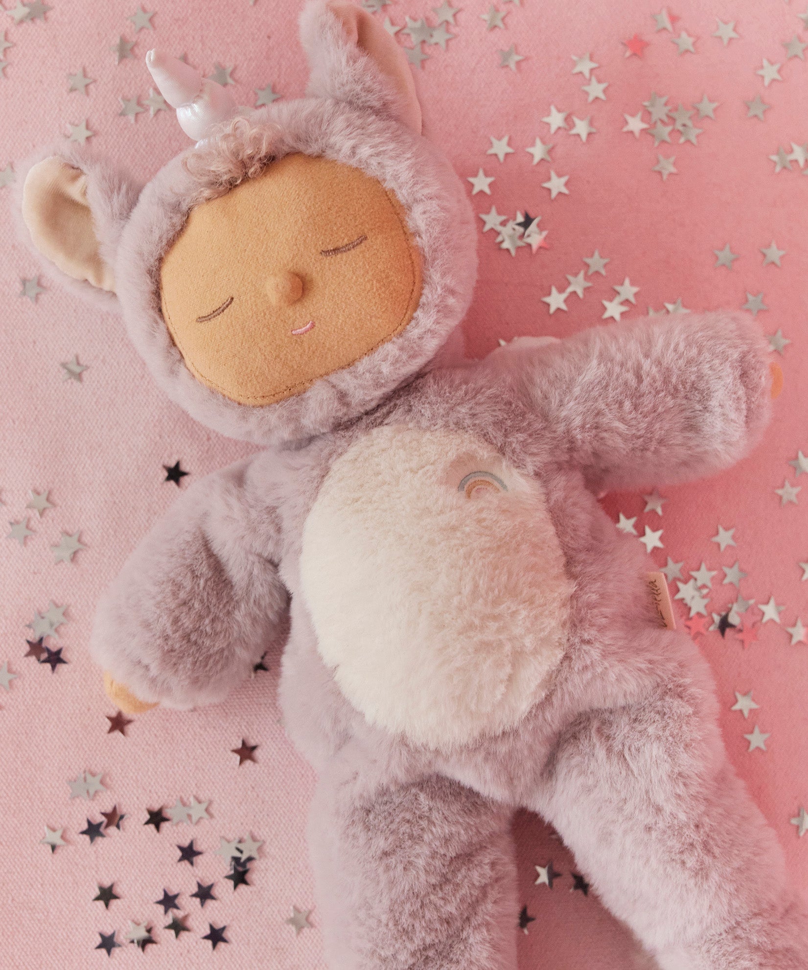 A lilac fluffy unicorn Olli Ella dozy dinkum doll lying down