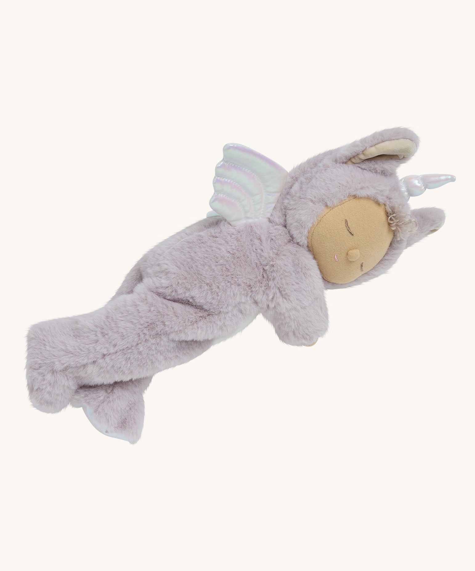 A lilac fluffy unicorn Olli Ella dozy dinkum doll lying down on a cream background