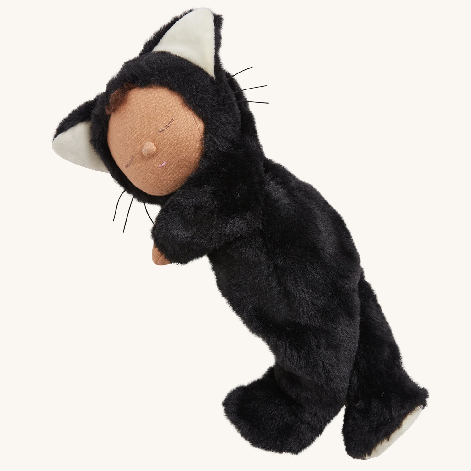 Olli Ella Cozy Dinkums - Black Cat Nox. A child carries Nox by the arm in an outdoor setting