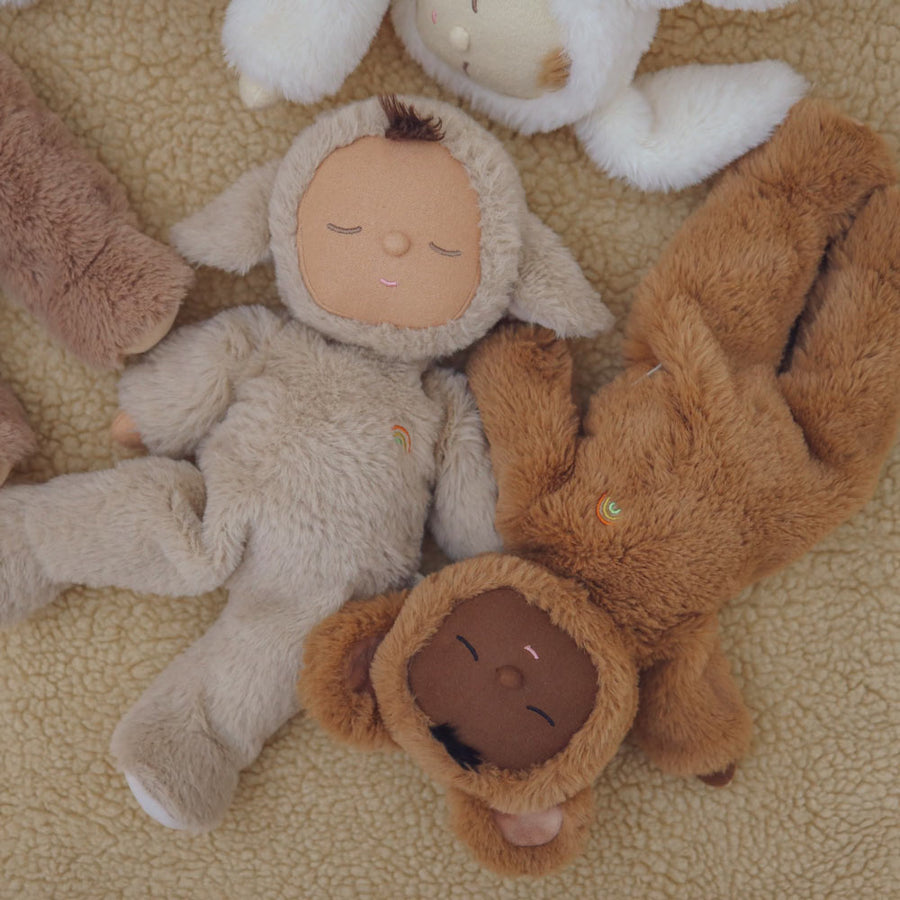 Olli Ella cuddly cozy dozy dinkum dolls laying on a fluffy blanket