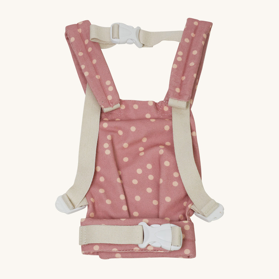 Back of the Olli Ella Pink Polka Dot Dinkum Doll Carrier pictured on a plain background