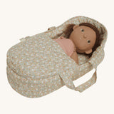 A dunkum Doll laying in the Olli Ella Garden Floral Gardenia print Dinkum Dolls Quilted Carry Cot 