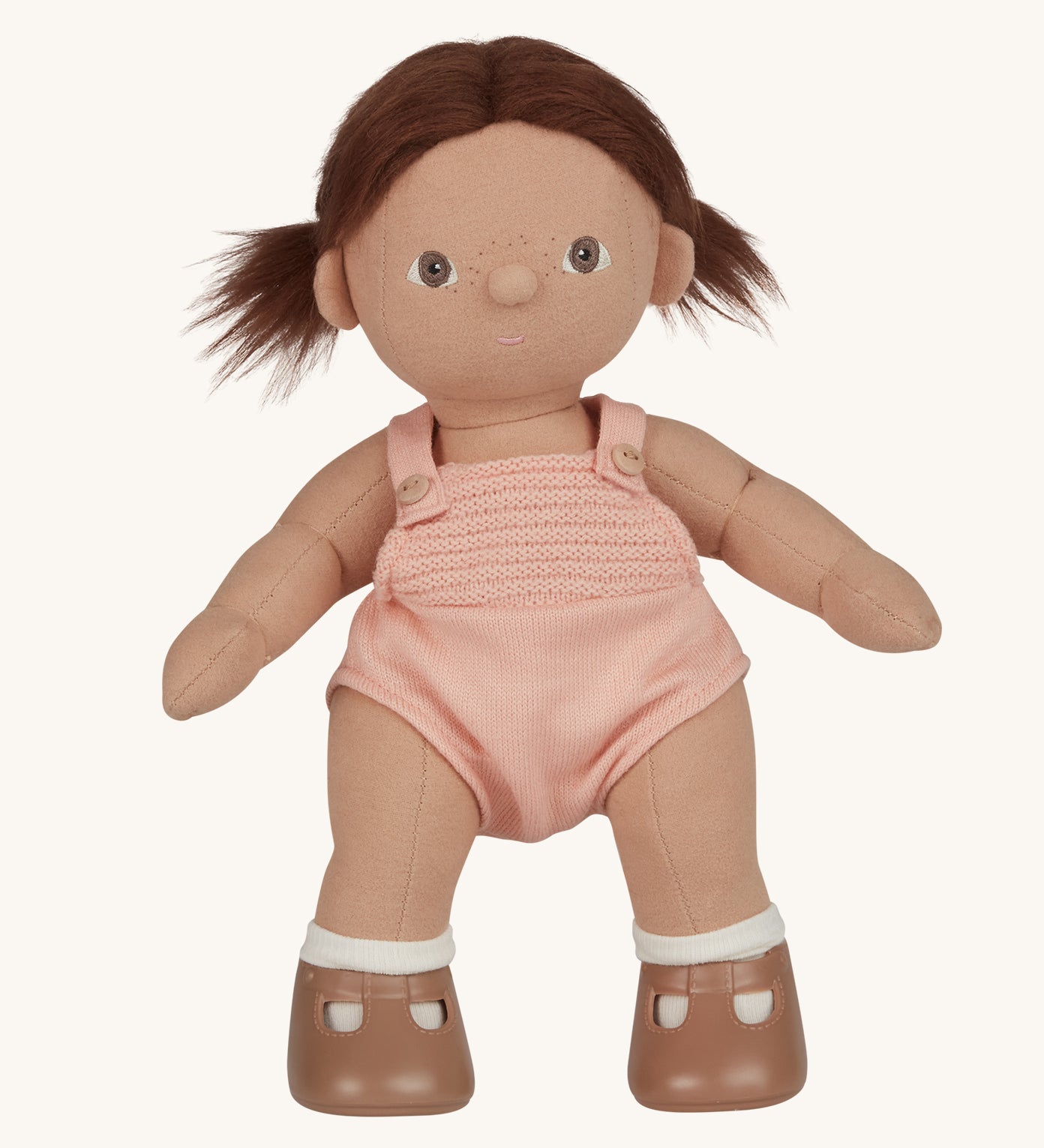 An Olli Ella Dottie Dinkum Doll on a plain background. The doll has brown hair and brown eyes. The hair is in pig tails.