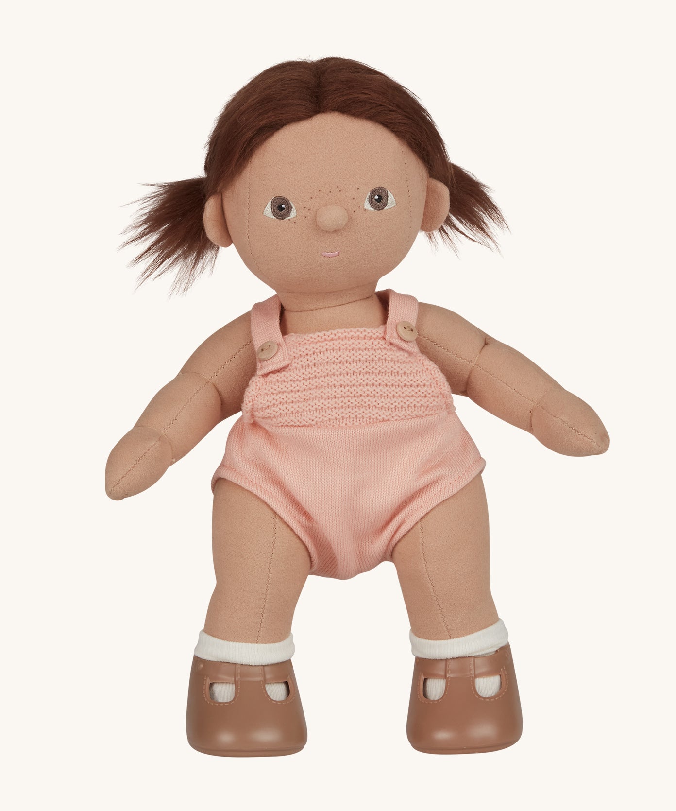 An Olli Ella Dottie Dinkum Doll on a plain background. The doll has brown hair and brown eyes. The hair is in pig tails.