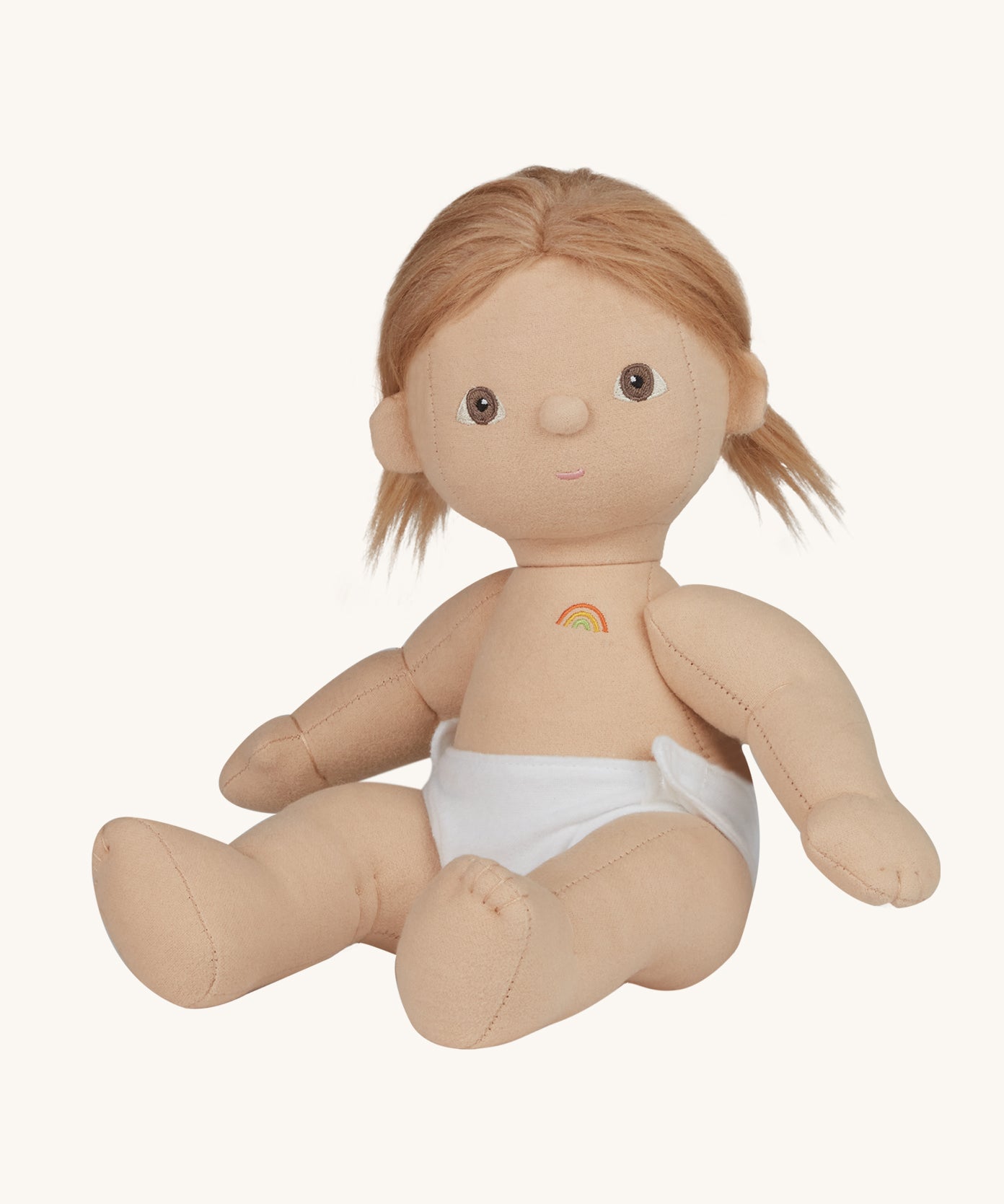 An Olli Ella Gigi Dinkum doll. The doll has blonde hair in pig tails and brown eyes. The doll is in a seated position and is wearing a white nappy. Shown on a plain background.  