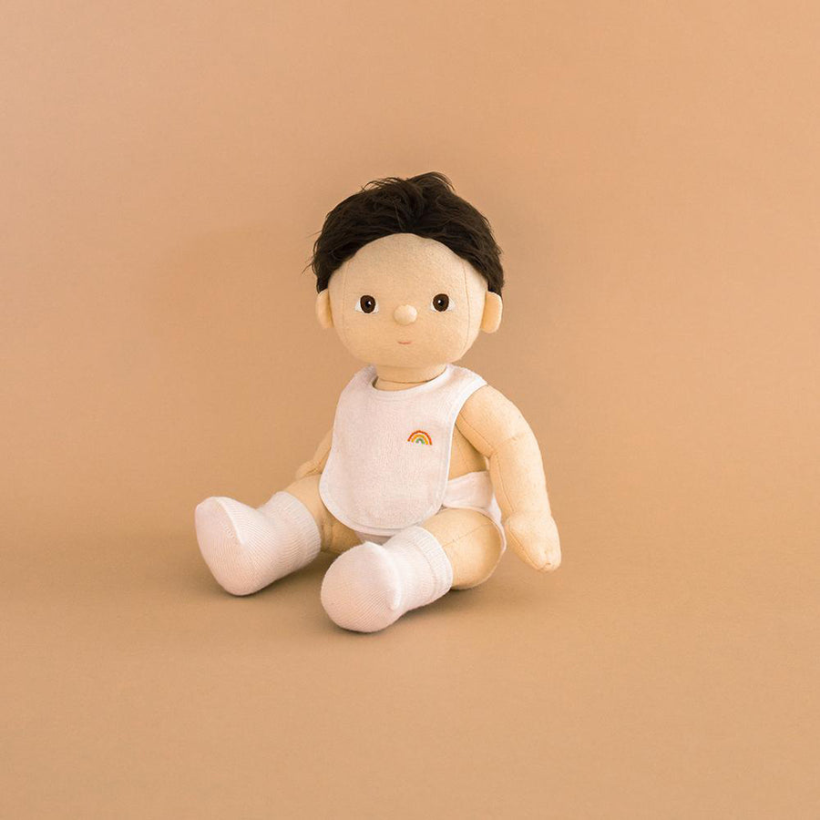 Olli ella childrens dinkum doll toy sat on a beige background wearing the dress up care clothing set