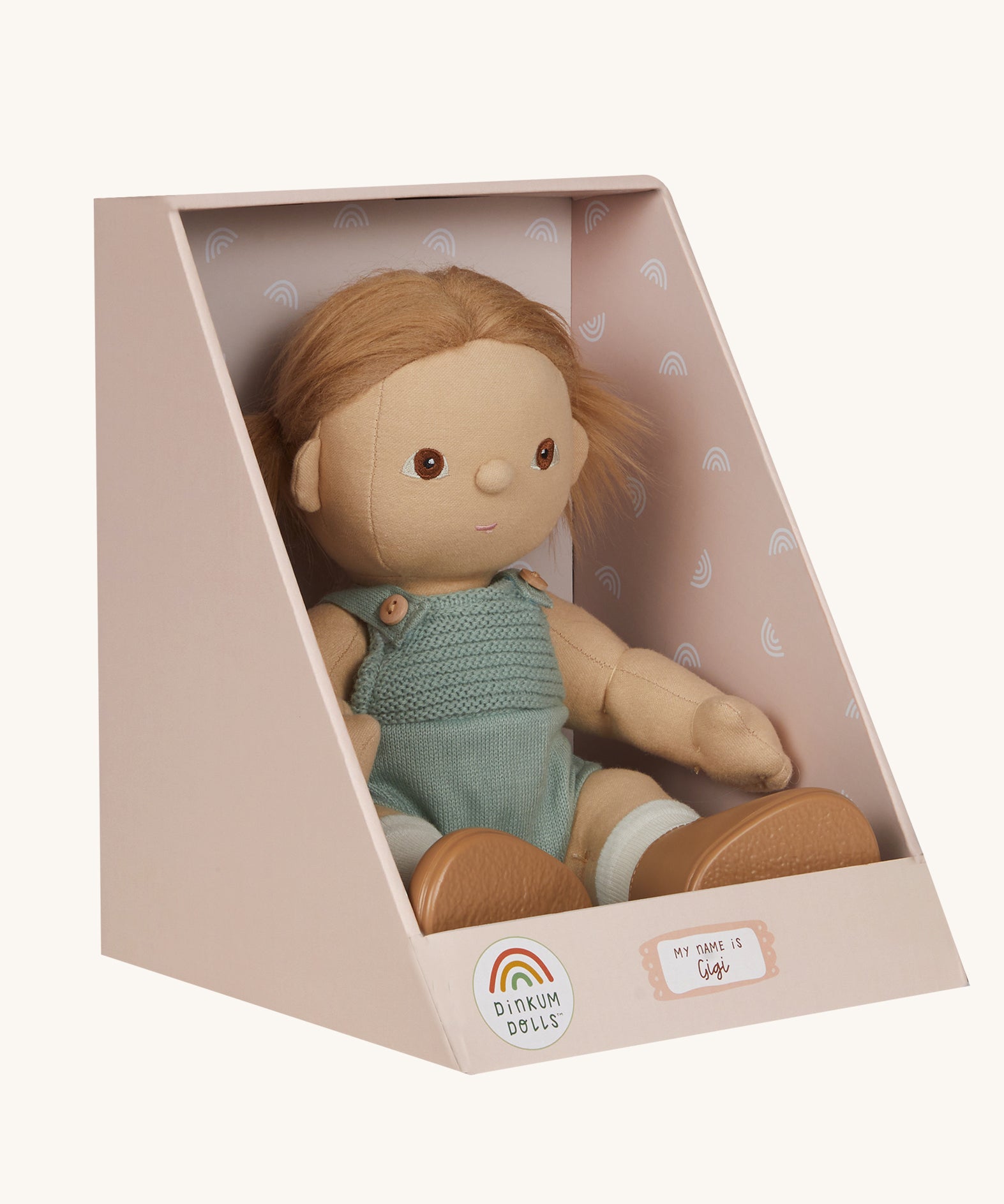 An Olli Ella Gigi Dinkum doll in a seated postion shown in it's cardboard box on a plain background. 