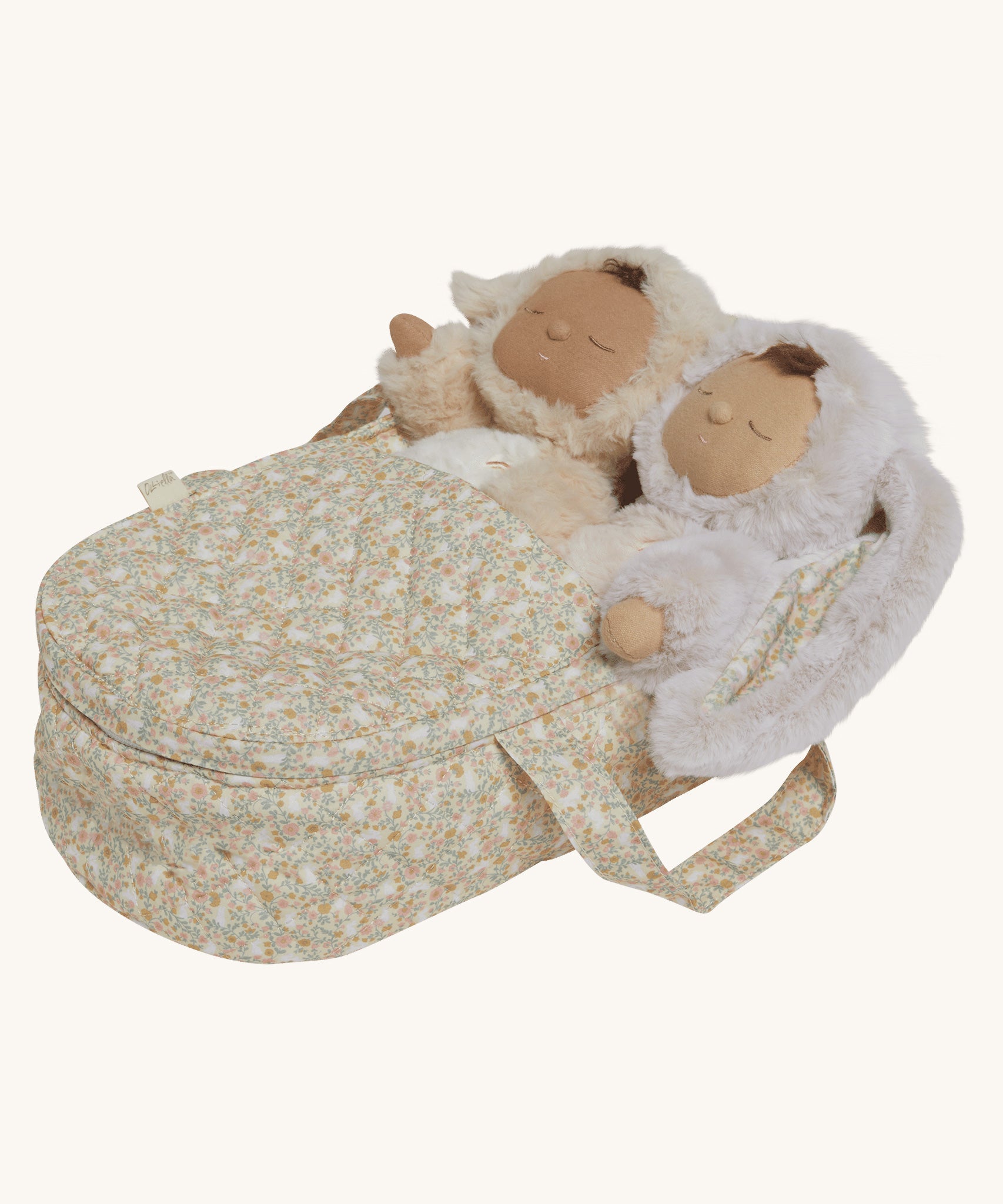 Two Dozy Dinkums laying side by side inside the Olli Ella Garden Floral Gardenia print Dinkum Dolls Quilted Carry Cot 
