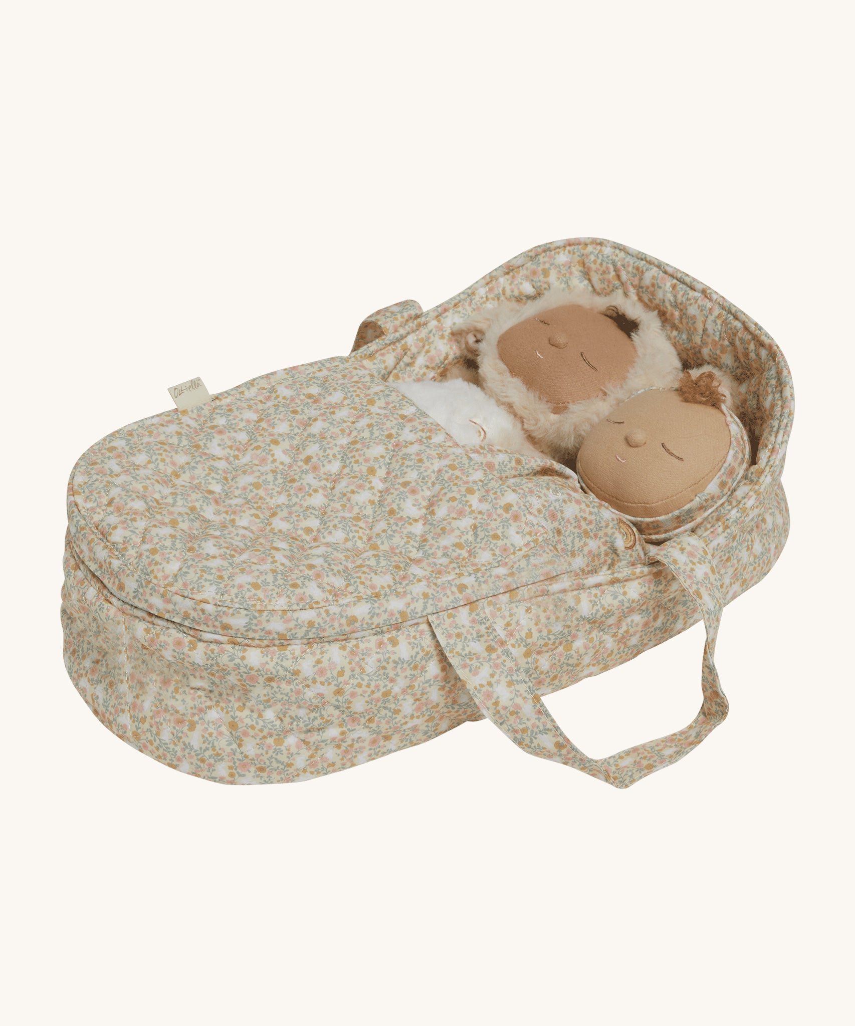 Two Dozy Dinkums laying side by side inside the Olli Ella Garden Floral Gardenia print Dinkum Dolls Quilted Carry Cot 
