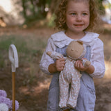 A child holding an Olli Ella Dozy Dinkum Doll Custard.