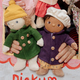 Two Dress Me Dinky dolls in a puppet show being held by a child. 