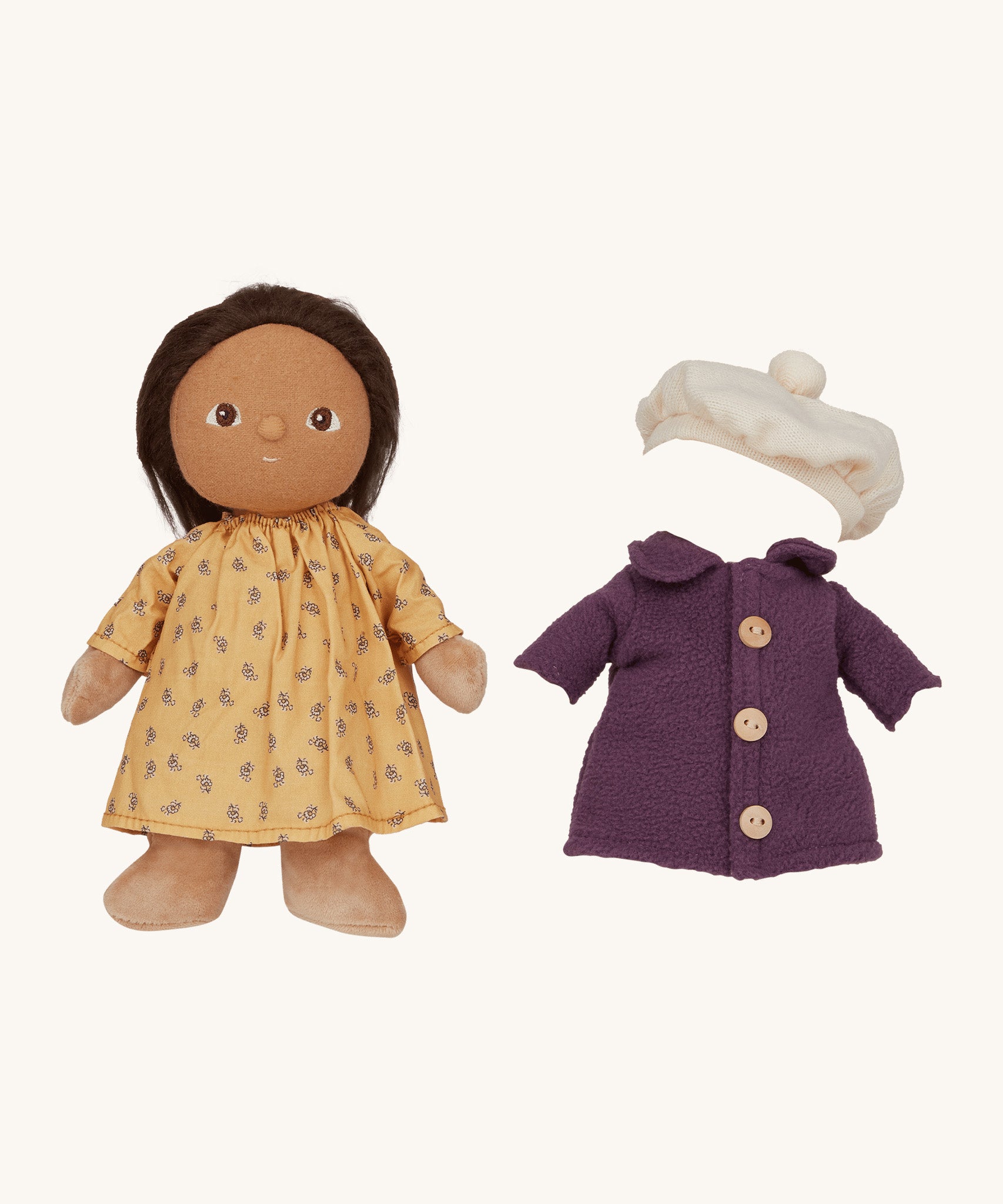 Olli Ella Dress Me Dinky - Lila Lavender wearing a yellow dress with a purple fleece trench coat and white beret beside her. Cream background. 