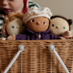 Three Dress Me Dinky dolls in a wicker basket.