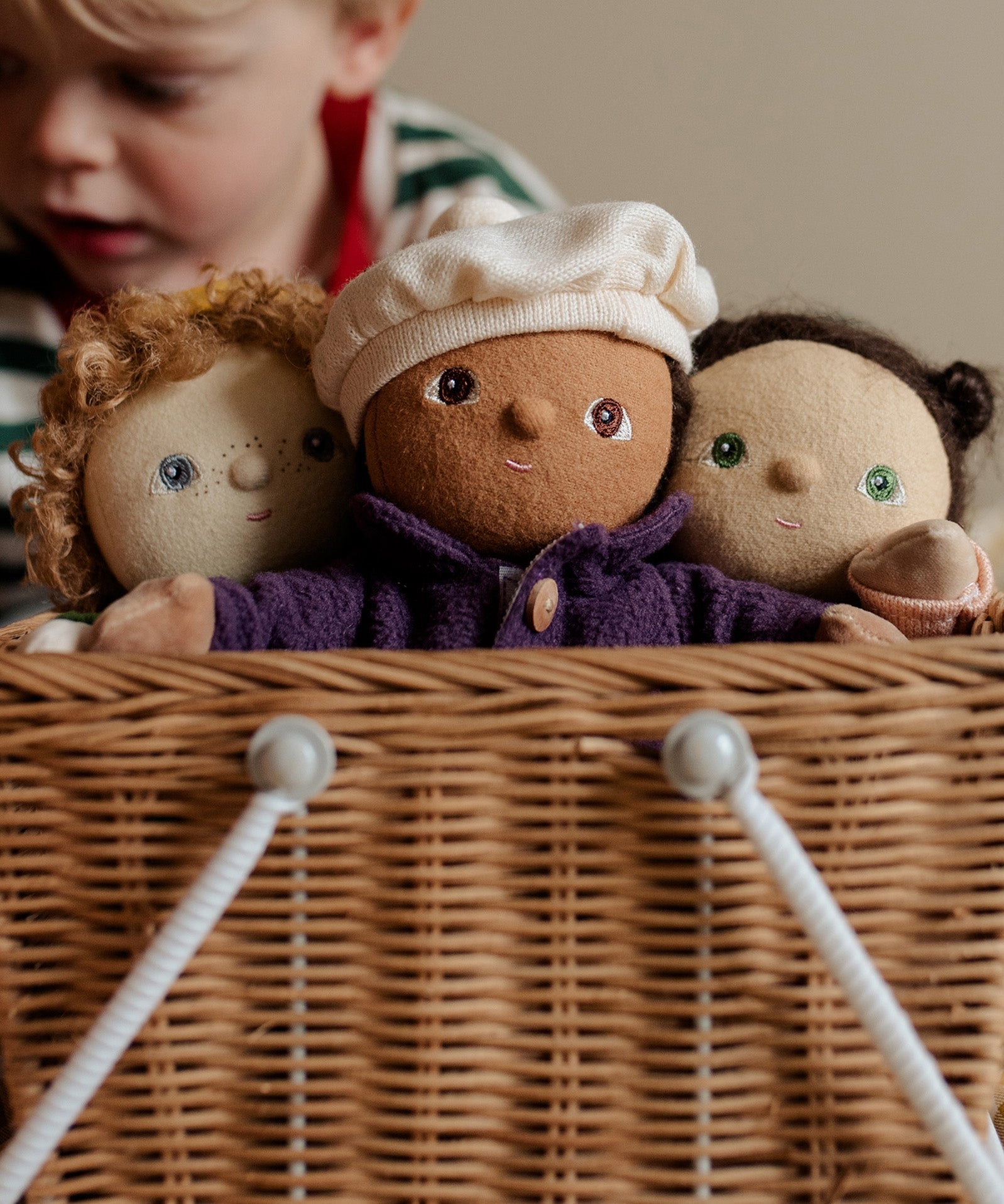 Three Dress Me Dinky dolls in a wicker basket.