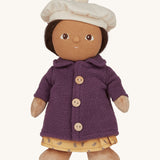 Olli Ella Dress Me Dinky - Lila Lavender wearing a purple fleece trench coat, yellow dress and white beret. Cream background. 