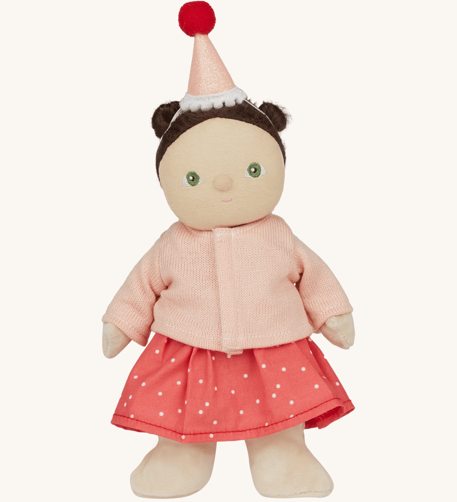 Olli Ella Dress Me Dinky - Sophie Sundae, a doll with brown hair and green eyes wearing a pink polka dot dress, light pink cardigan and a pink party hat. Cream background.