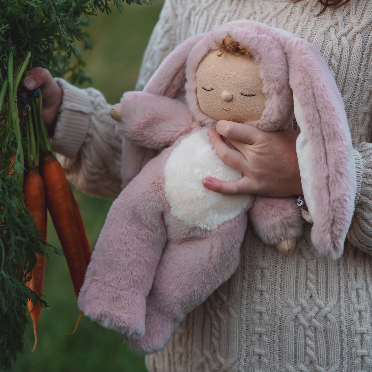 long fluffy pink ears attatched to the hood of their onesie