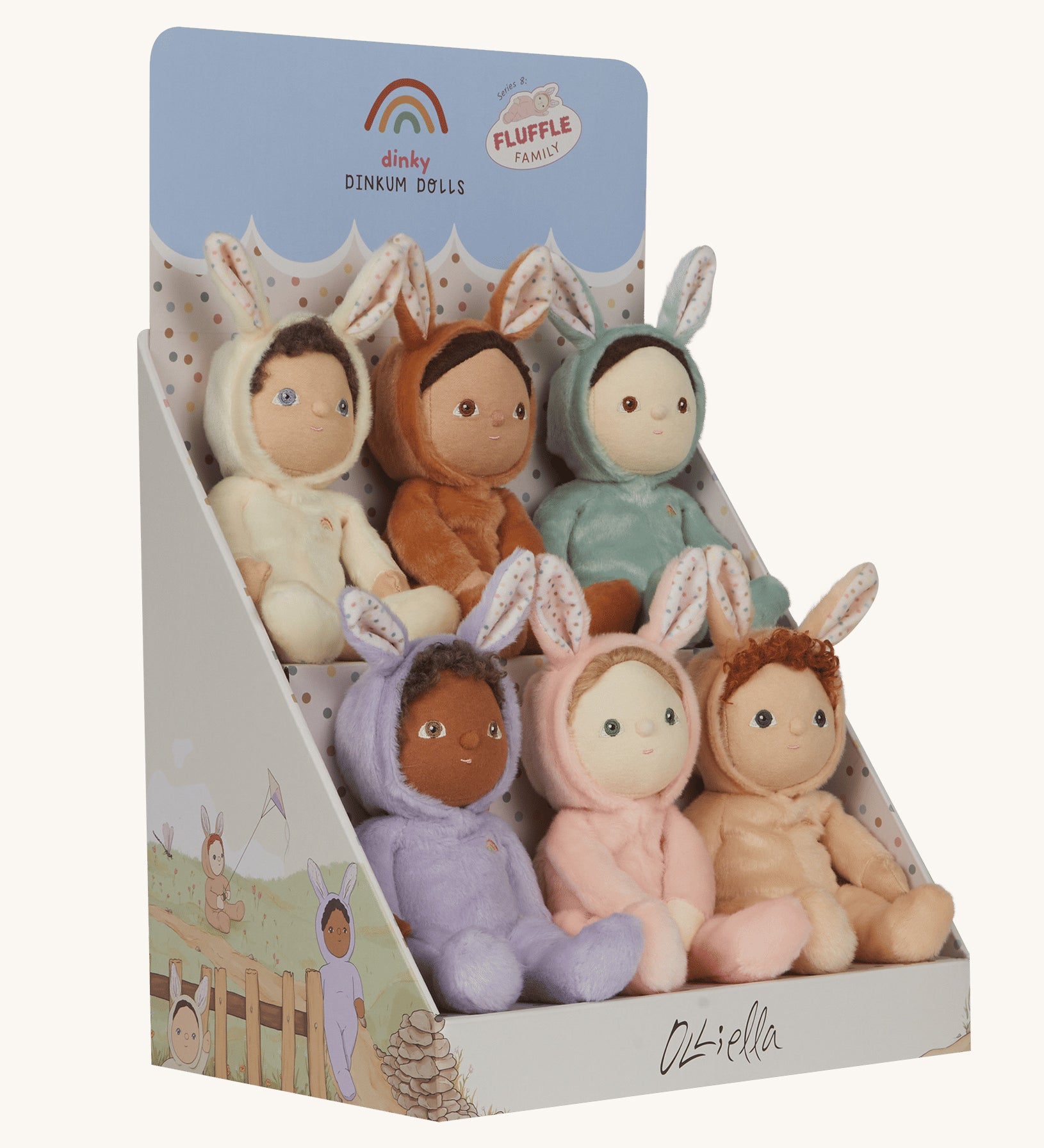 Olli Ella Dinky Dinkum Fluffle Family Bunny Dolls in their cardboard display stand. There are 6 bunnies in total including Babbit, Babs, Basil, Bubba, Biscuit and Bucky. The box is pictured at an angle showing the illustrations of the bunnies on the side of the stand.