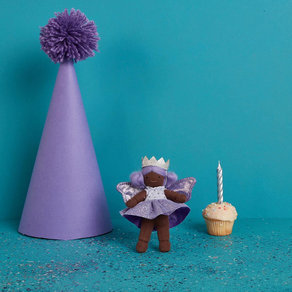 Tulip and Willow on the lap and hand of a child wearing a purple tulle tutu