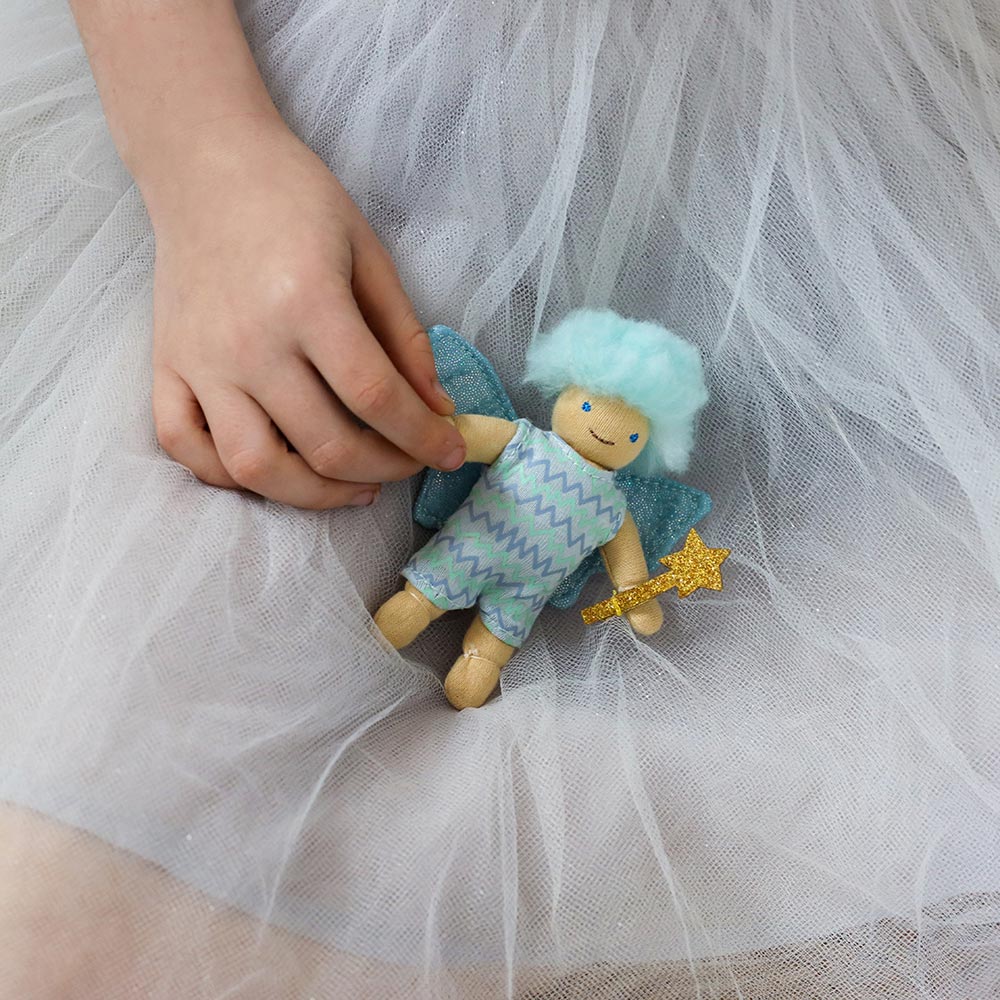 Tulip and Willow on a tulle skirt held in a childs hand