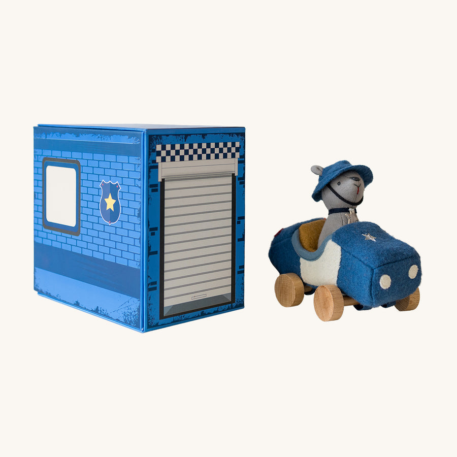 Child playing with Olli Ella Holdie Dog-go Officer and Girl Racer toy outside