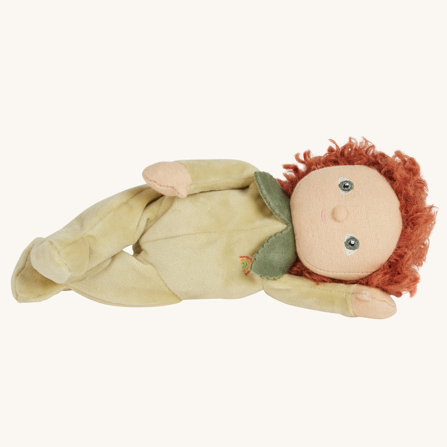 Olli Ella green kids soft doll toy laying on a beige background