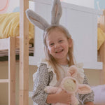 A child wearing the grey Olli Ella Fluffle Bunny Ear Headband.