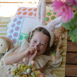 A child wearing the pink Olli Ella Fluffle Bunny Ear Headband in Pink.