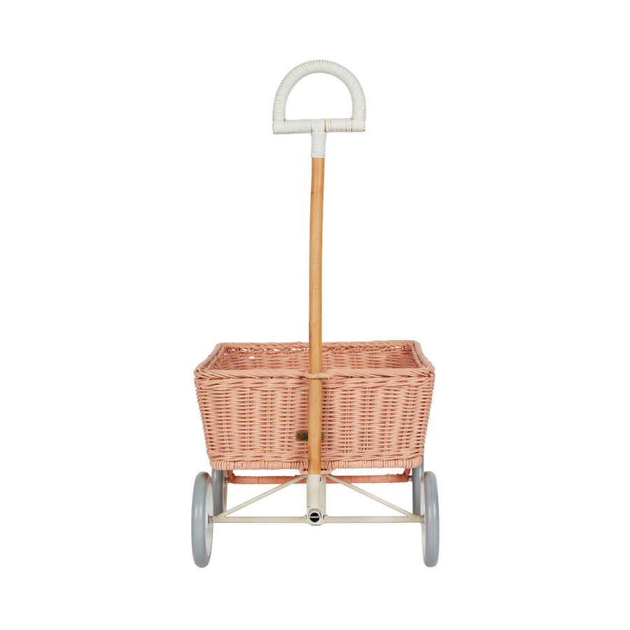 Front of the light pink Olli Ella rattan toy wagon on a white background