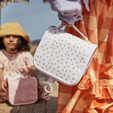 a child holding on to the Olli Ella leafed mushrooms See-Ya Wash Bag