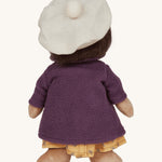 Olli Ella Dress Me Dinky - Lila Lavender wearing a purple fleece trench coat, yellow dress and white beret. Rear view, cream background. 