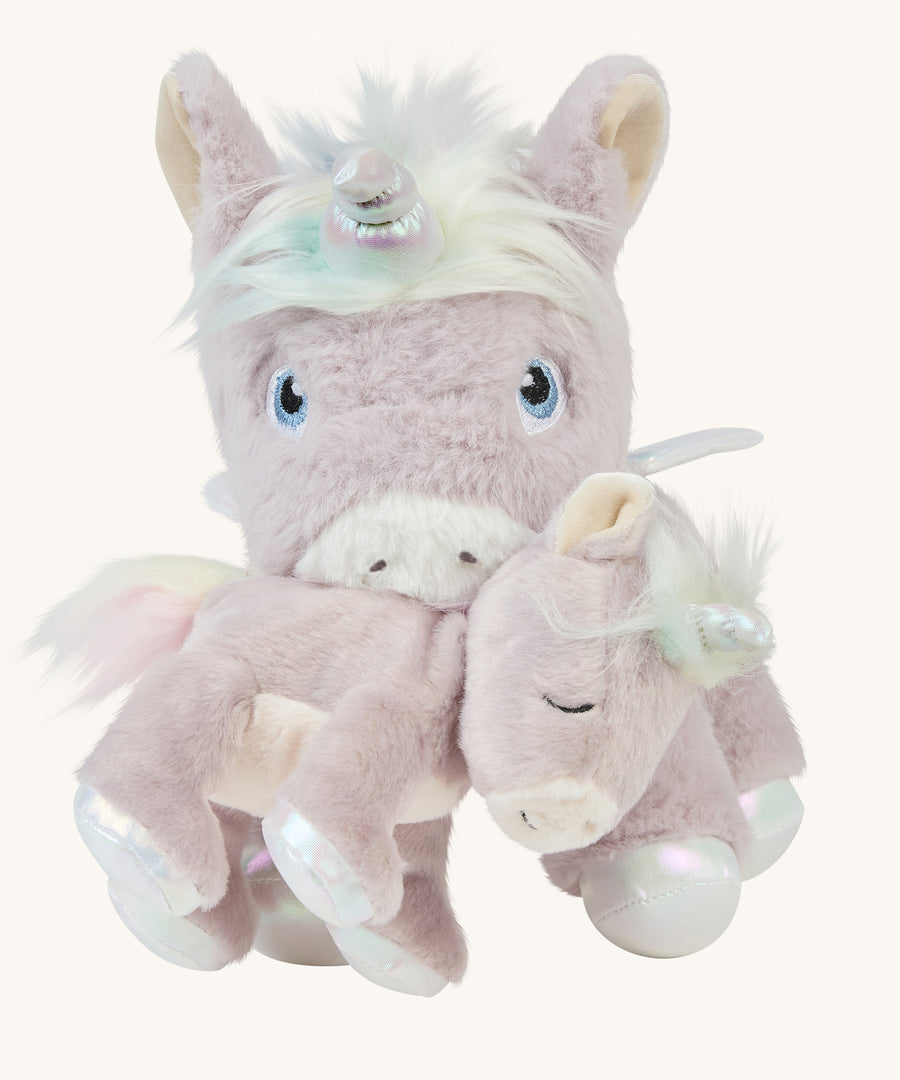 The dinkum unicorn is holding the baby unicorn with its magnetic mouth