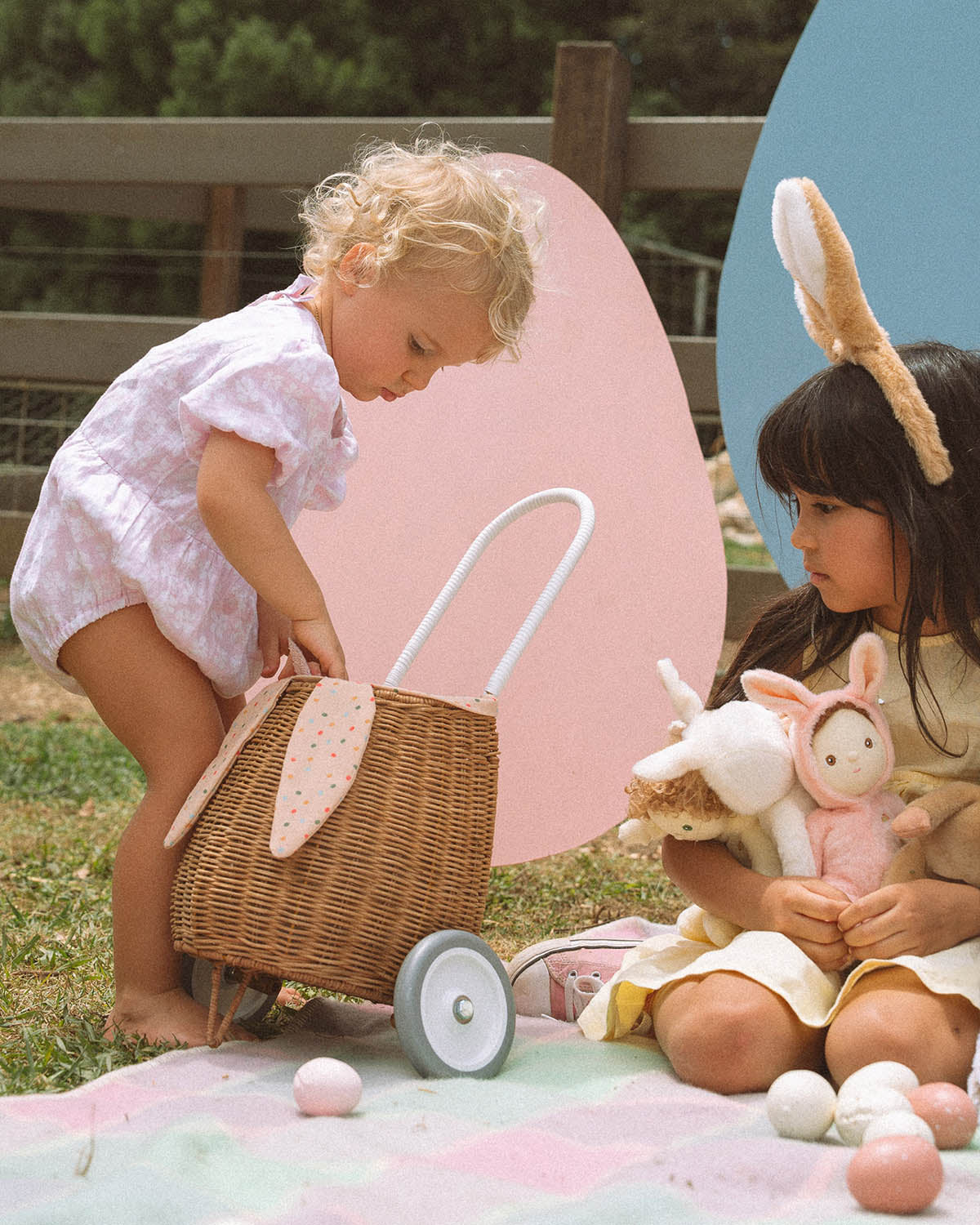 surrounded by Cosy Dinkum dolls and colourful toy eggs