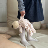 Olli Ella Lullaby Dozy Dinkum Doll - Luna is posed in a sleeping position on a floral blanket.