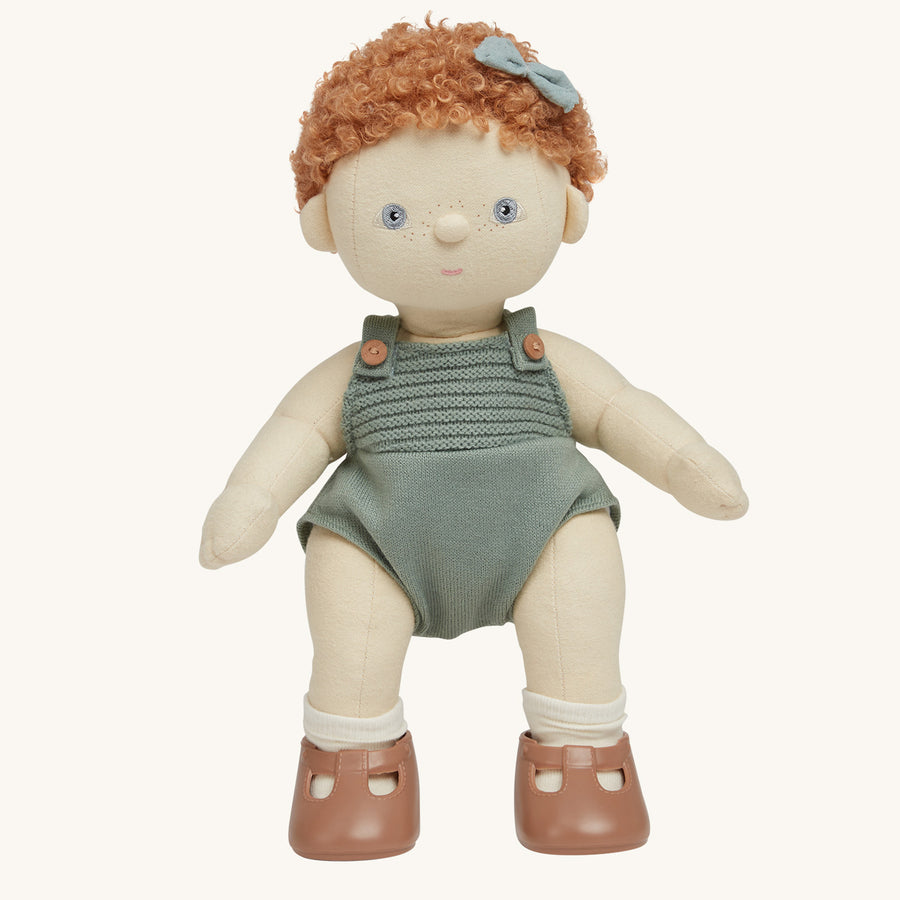 Dinkum Doll standing up pictured on a plain coloured background