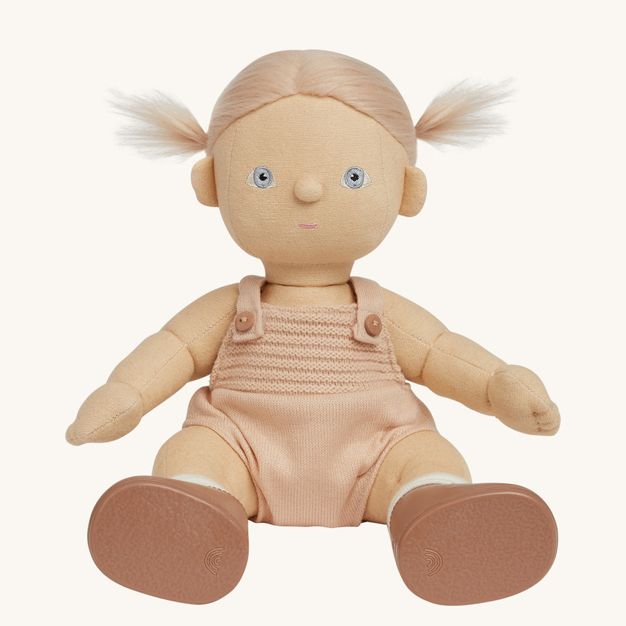 Dinkum Doll standing up pictured on a plain coloured background