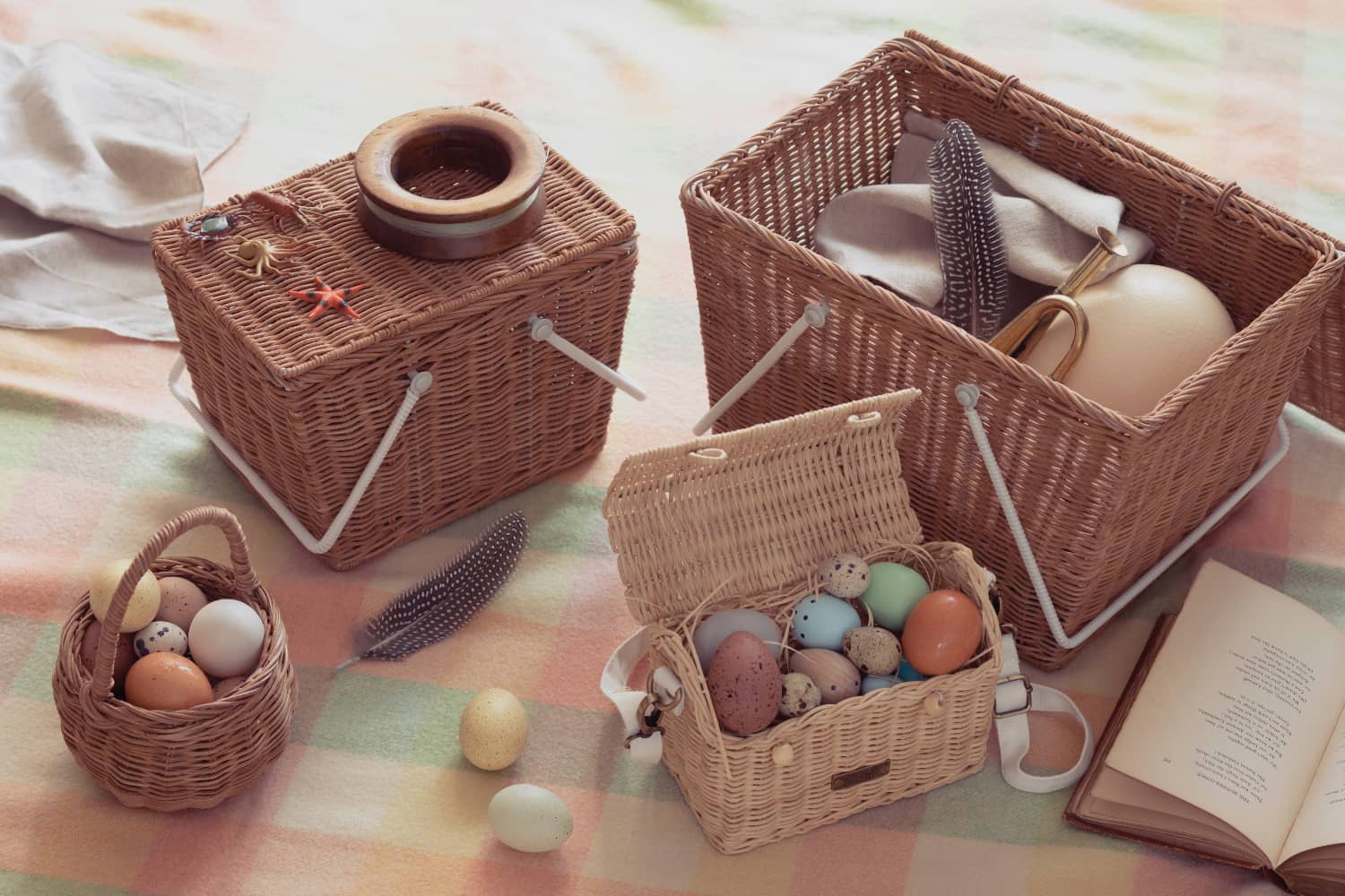 a rattan picnic basket with white handles