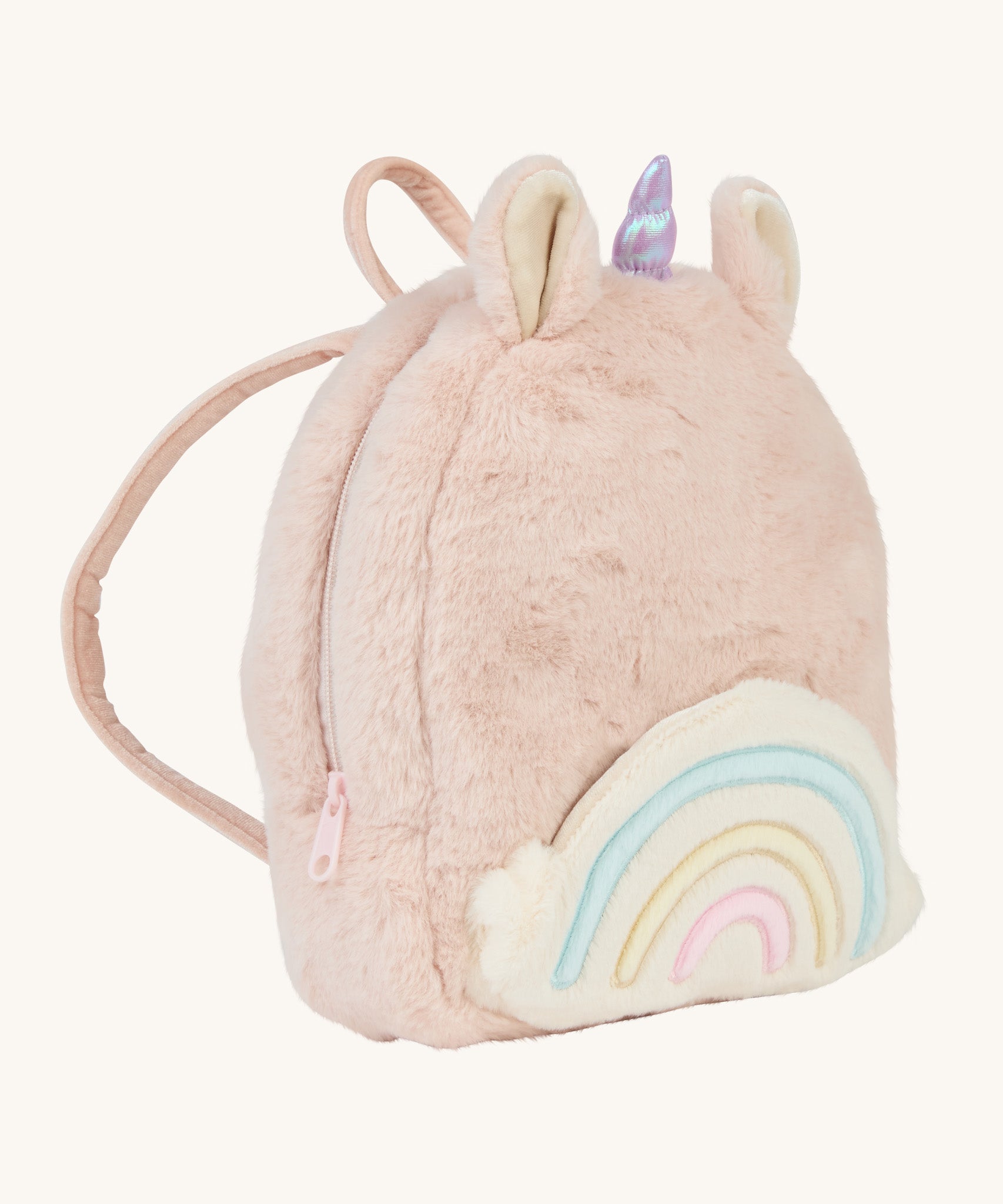 A OIli Ella pink fluffy unicorn backpack with a rainbow on the front on a cream background.