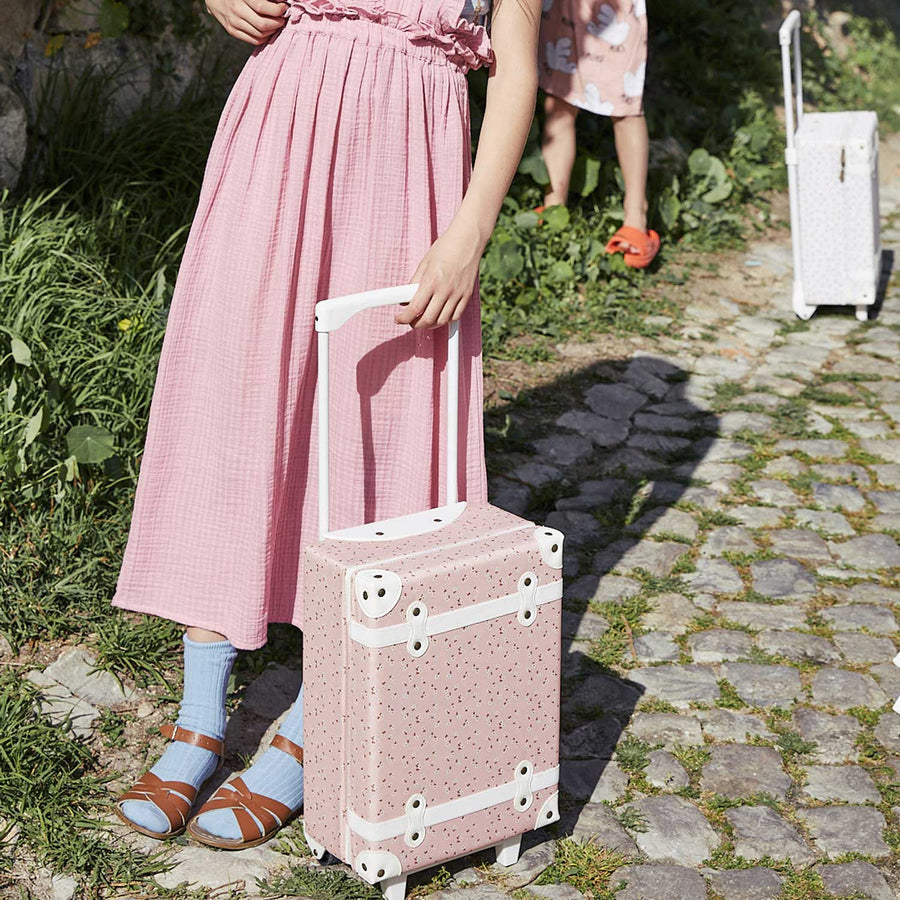 Collection of four Olli Ella See-ya suitcases showing handles at different heights  pictured on a plain background