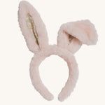 The Olli Ella Fluffle Bunny Ear Headband in Pink on a plain background. One ear is shown folded over.