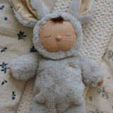 An Olli Ella Pip Lullaby Cozy Dinkum Bunny laying on blankets.